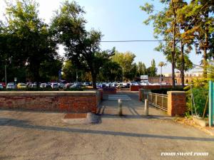 a brick wall and a parking lot with cars at Room sweet Room in Bologna +24 photos