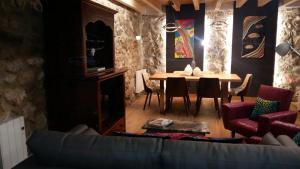 a living room with a table and a couch at Casas La Xiuca in Corras de la Puente