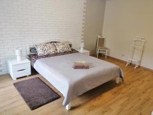 a bedroom with a bed with two towels on it at Apartment "Provence" in Chernihiv
