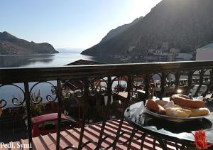 a plate of hot dogs on a table on a balcony at Korali in Symi