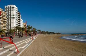 una playa de arena con edificios y el océano en Vinaròs junto al mar, en Vinarós