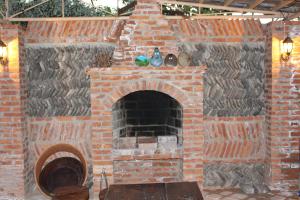 an outdoor brick oven with a stone wall at Guest House Daviti in Zestafoni