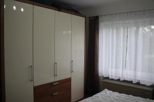 a bedroom with a bed and a dresser and a window at Ferienwohnung Baum in Winterberg in Winterberg