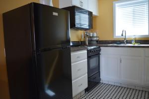 a kitchen with a refrigerator, stove, sink and dishwasher at Dew Drop Inn in Forks