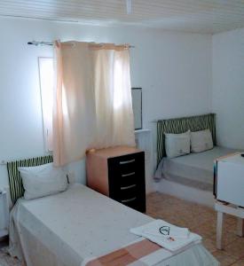 A bed or beds in a room at Pousada Asa Branca