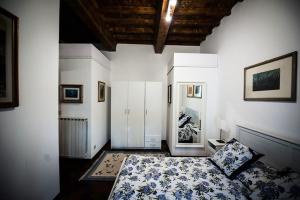 a bedroom with a bed in a room with white walls at Luxury central flat river view in Florence