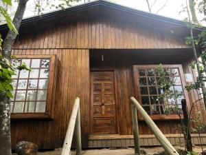 a small wooden cabin with a large door at Cabañas Boutique - El Renegado Y Rustica in Recinto
