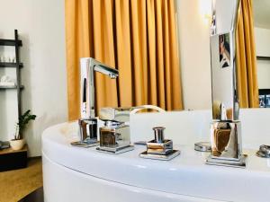 a bathroom with a sink and a mirror at SPA Hotel in Vorzelʼ