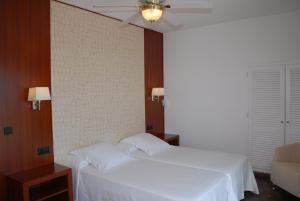Postel nebo postele na pokoji v ubytování Hotel Grifeu