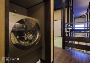 a washing machine in a room with a staircase at Houka in Kyoto