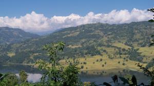 a view of a valley with a lake and mountains at Dinesh House in Pokhara