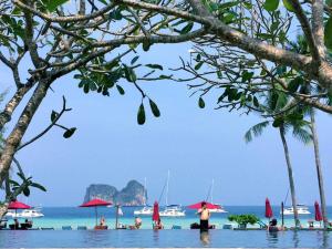 a group of people in the water at a beach at Thanya Beach Resort - SHA Plus in Ko Ngai