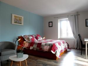 1 dormitorio con 1 cama, 1 silla y 1 ventana en Maison Curiale, en Montreux-Château