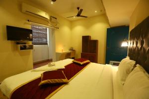 a hotel room with a bed and a television at Zingle Stay Airport in Chennai