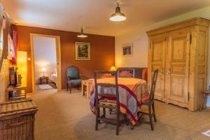 a bedroom with a bed with a table and chairs at Gite Le Cerneux Haut Doubs in La GrandʼCombe-Châteleu