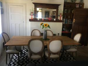 a dining room table with chairs and a vase of flowers at The Inn At The Convent in Taumarunui +8 photos