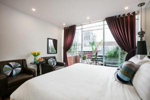 a bedroom with a large bed and a large window at Splendid Star Grand Hotel and Spa in Hanoi