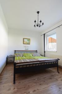a bedroom with a bed in a room with a window at Ferienwohnungen Karoly in Mörbisch am See