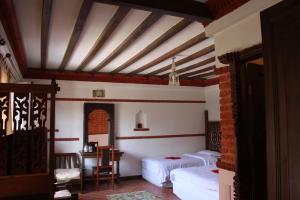 A bed or beds in a room at Hotel Manaslu