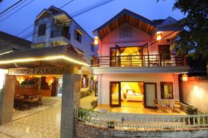 a house with a patio in front of it at Tam Coc Tuan Minh Homestay in Ninh Binh