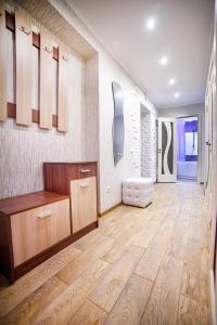een woonkamer met een houten vloer en een grote kamer bij 2-комн ЛЮКС в центре Вишенки in Vinnytsya