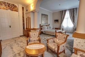 a living room filled with furniture and a large window at Hotel Restaurant Odeon in Plovdiv