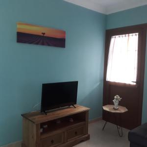 TV a/nebo společenská místnost v ubytování Casa Girdana