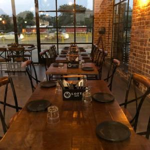 a row of wooden tables in a restaurant at Hotel Spiti in Mathura +12 photos
