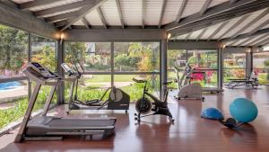 a gym with several exercise equipment in a room with windows at Precise Resort El Rompido-The Hotel in El Rompido