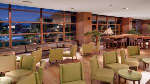 a restaurant with chairs and tables and a bar at Precise Resort El Rompido-The Hotel in El Rompido