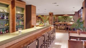 a restaurant with a bar and a dining room at Precise Resort El Rompido-The Hotel in El Rompido