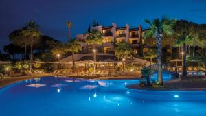 a resort with a swimming pool at night at Precise Resort El Rompido-The Hotel in El Rompido