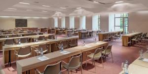 an empty lecture hall with tables and chairs at Precise Resort El Rompido-The Hotel in El Rompido