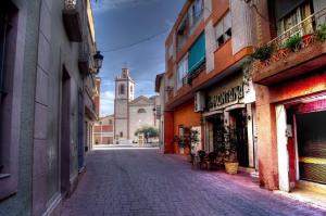 an empty street in a town with a church at Apartment Segura 2BD in Rojales