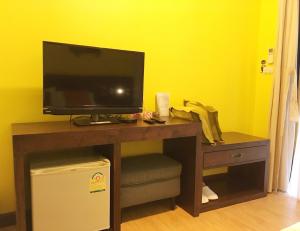 a desk with a television on top of it at Kongkarn Resort and Farmstay in Ban Pak Ngam