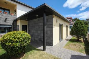 a house with a black and white at Cabo da Vila Guesthouse in Ribeira Grande