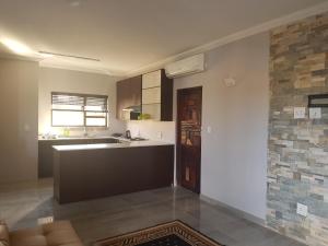 a kitchen with a sink and a counter top at Sunflower Guesthouse in Vanderbijlpark