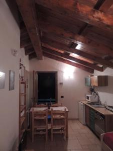 a kitchen with wooden ceilings and a tv in a room at Ico's Lodge in Sauze dʼOulx