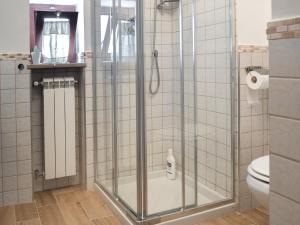 a shower with a glass door in a bathroom at B&b A casa di Maybe in Caserta