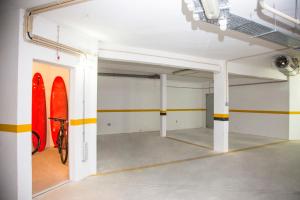 a room with a surfboard in it with a room with a room at Sagres Time Apartamentos in Sagres