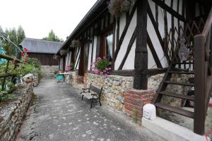 a building with a bench in front of it at Le Clos des Hortensias in Toutainville