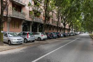 a row of cars parked on the side of a street at La Terrazza Sul Po in Turin