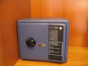 a blue microwave with a black button on a wall at Hotel Aquila D'Oro in Misano Adriatico