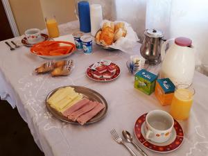 a table topped with plates of food and breakfast foods at Recanto Das Borboletas in São Roque