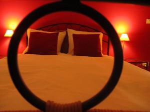a bedroom with a white bed with red walls at De Loteling in Zoersel