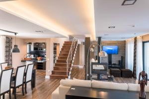 a living room with a couch and a table at Atlantic Heritage Luxury Villa in Madalena