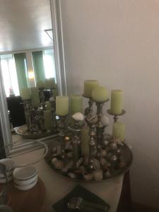 a bathroom with a mirror and a table with candles at Hotel Sechzehn in Leverkusen
