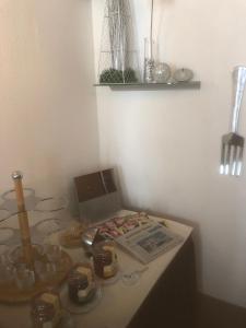 a table with dishes and a book on it at Hotel Sechzehn in Leverkusen