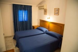 Postel nebo postele na pokoji v ubytování Hostal Acuario