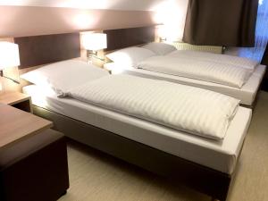 Postel nebo postele na pokoji v ubytování Hana Aparthotel